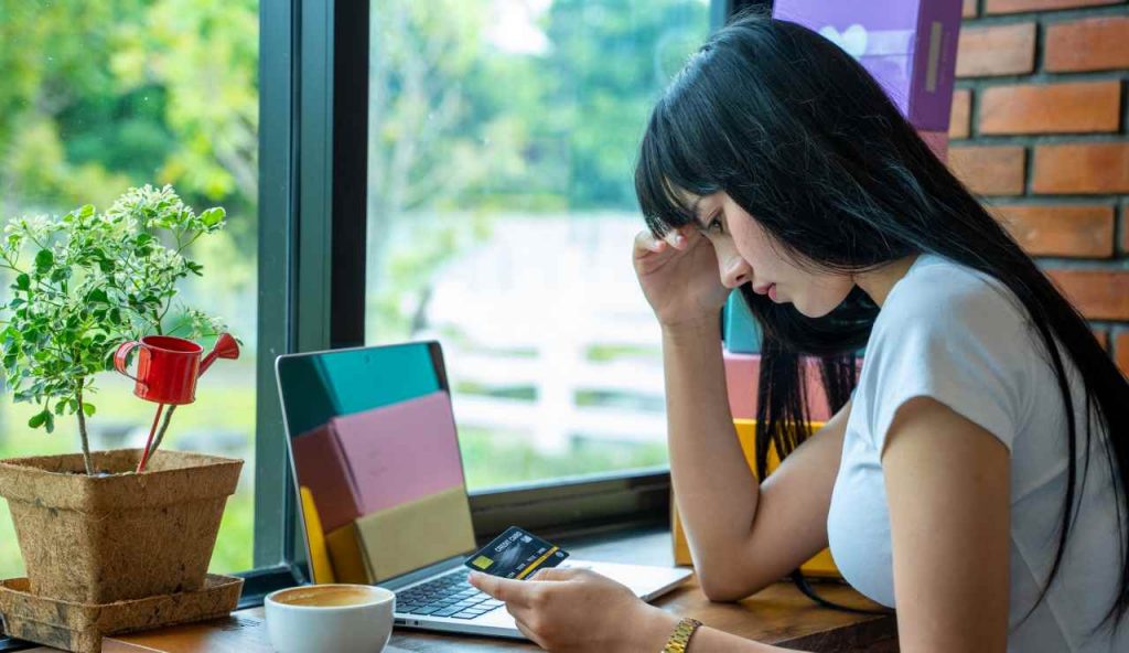 Ragazza disperata in un bar che ha scoperto di avere il conto corrente bloccato